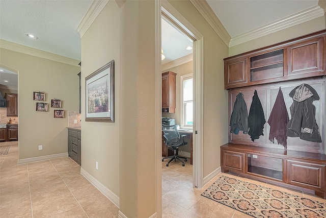 mudroom featuring ornamental molding and light tile patterned flooring