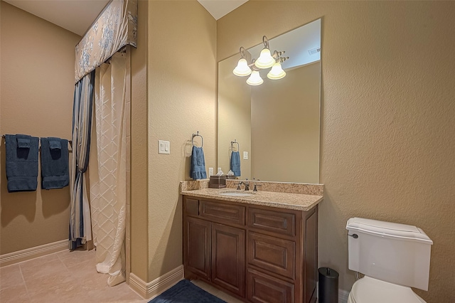 bathroom featuring tile patterned flooring, vanity, and toilet