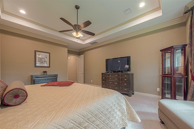 bedroom with a tray ceiling, ceiling fan, carpet flooring, and crown molding