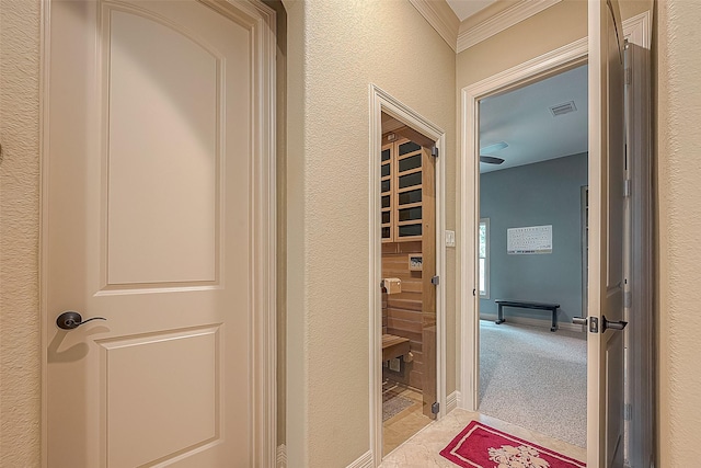 hallway featuring light colored carpet and ornamental molding