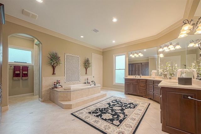 bathroom with vanity, ornamental molding, tiled tub, and a chandelier