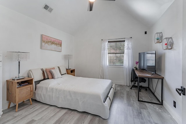 bedroom with ceiling fan, high vaulted ceiling, and light hardwood / wood-style flooring