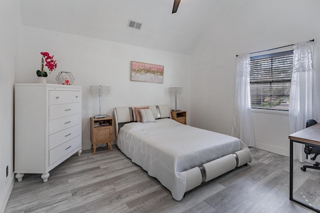 bedroom featuring ceiling fan, vaulted ceiling, and light hardwood / wood-style flooring