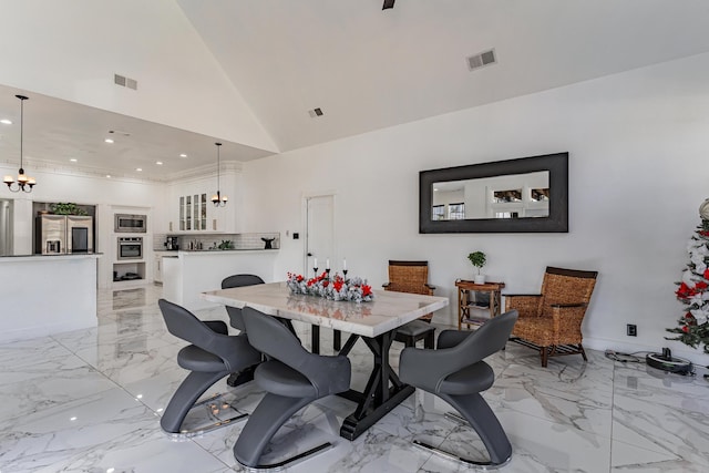 dining space with high vaulted ceiling