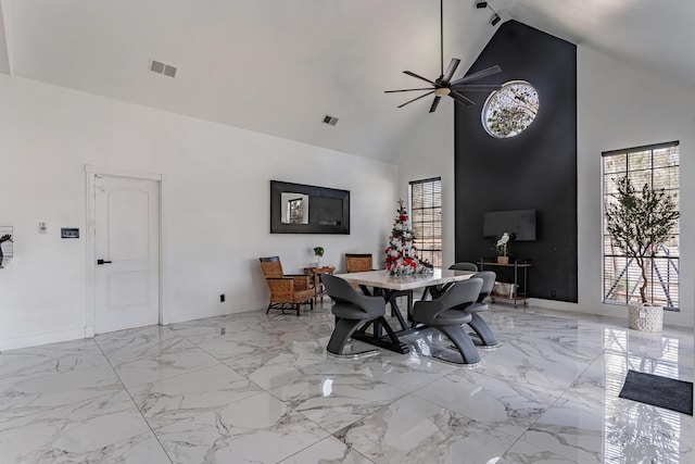 dining space with high vaulted ceiling and ceiling fan