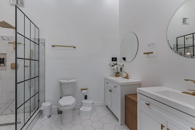 bathroom with tile patterned flooring, vanity, toilet, and tiled shower