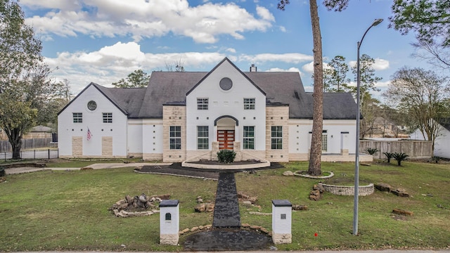 french country home featuring a front yard