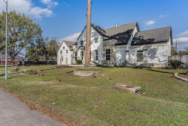 view of front of house with a garage and a front lawn