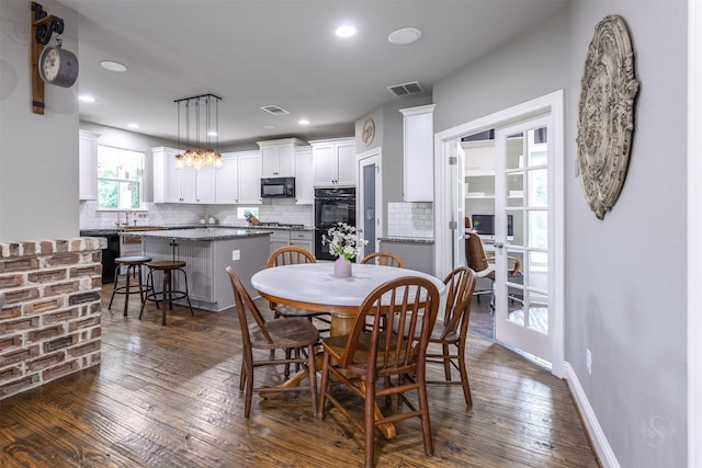 dining area with sink and dark wood-type flooring