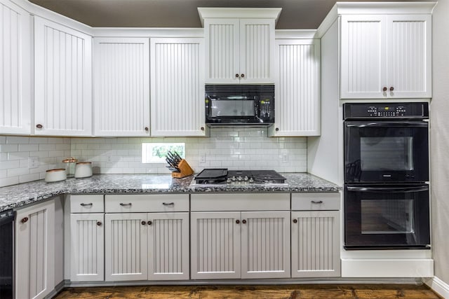 kitchen featuring black appliances, light stone counters, white cabinetry, and tasteful backsplash