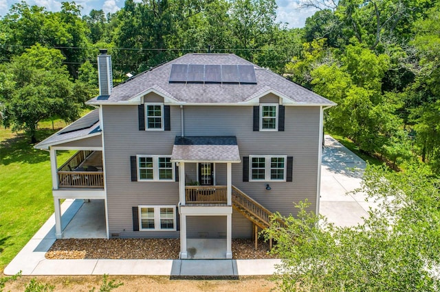 front of property with a front lawn and solar panels