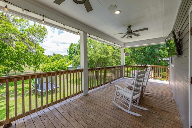 wooden terrace with a yard and ceiling fan