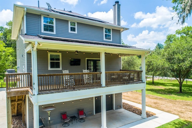 back of house featuring a lawn and a patio area