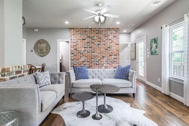 living room featuring ceiling fan and dark hardwood / wood-style flooring