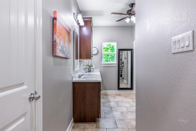 bathroom with tile patterned flooring, vanity, and ceiling fan