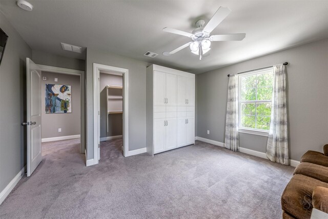 living area with ceiling fan and light colored carpet