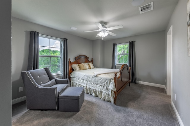 bedroom with carpet floors, multiple windows, and ceiling fan