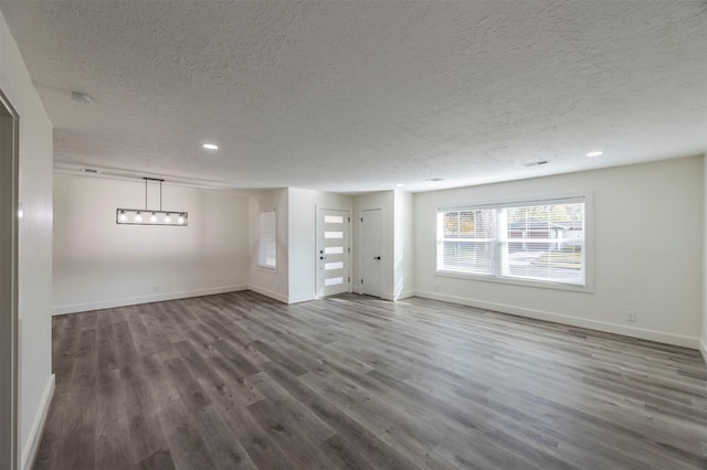 interior space featuring dark hardwood / wood-style floors and a textured ceiling