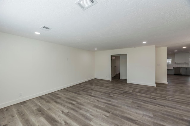 interior space with a textured ceiling and dark hardwood / wood-style floors