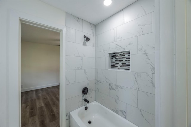 bathroom with tiled shower / bath combo and hardwood / wood-style flooring