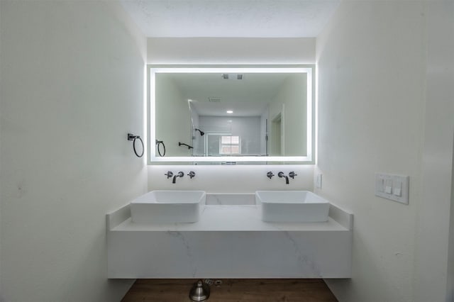 bathroom with a shower and vanity