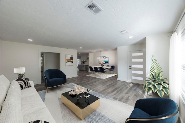 living room with hardwood / wood-style floors and a textured ceiling