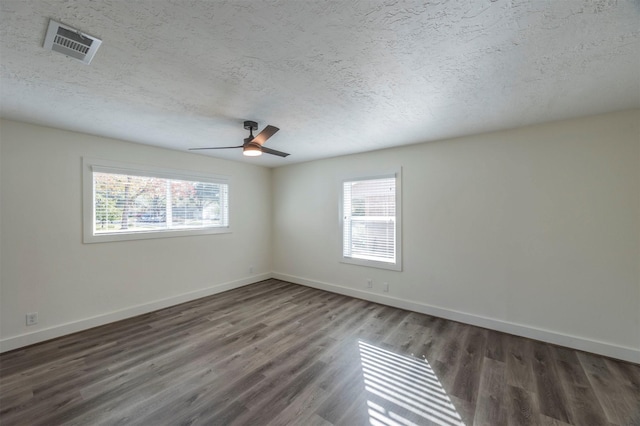 spare room with ceiling fan, dark hardwood / wood-style flooring, and a textured ceiling