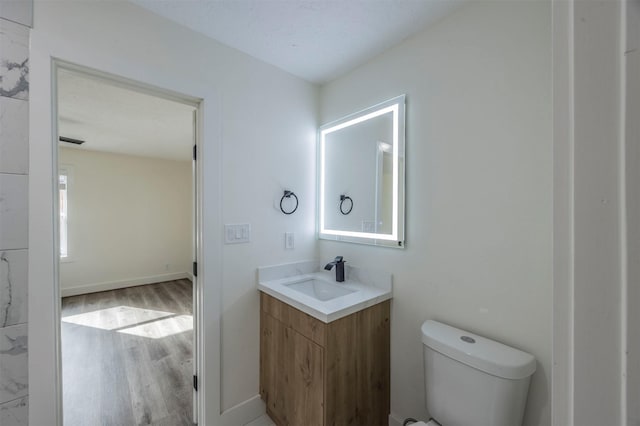 bathroom featuring hardwood / wood-style floors, vanity, a textured ceiling, and toilet