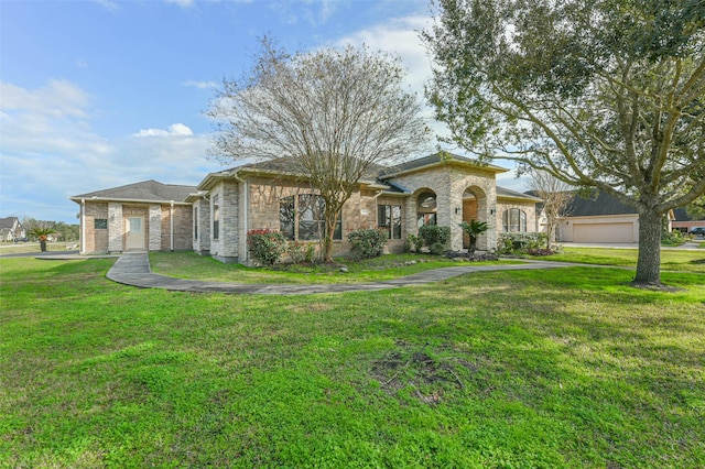 ranch-style house featuring a garage and a front lawn