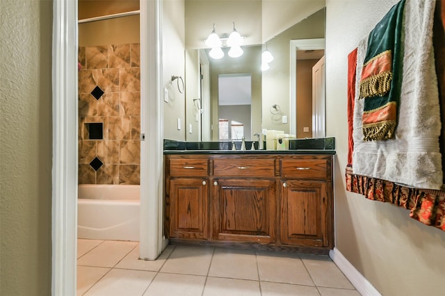 bathroom with tile patterned flooring, vanity, and tiled shower / bath