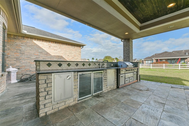 view of patio / terrace with an outdoor kitchen, area for grilling, and sink