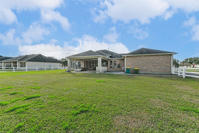 rear view of property with a lawn and a patio area