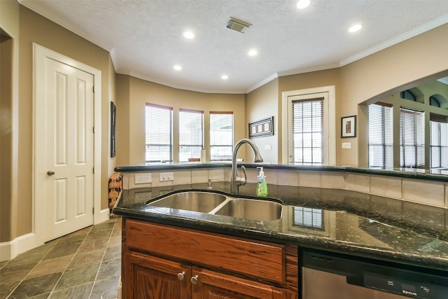 kitchen featuring stainless steel dishwasher, dark stone countertops, sink, and a textured ceiling