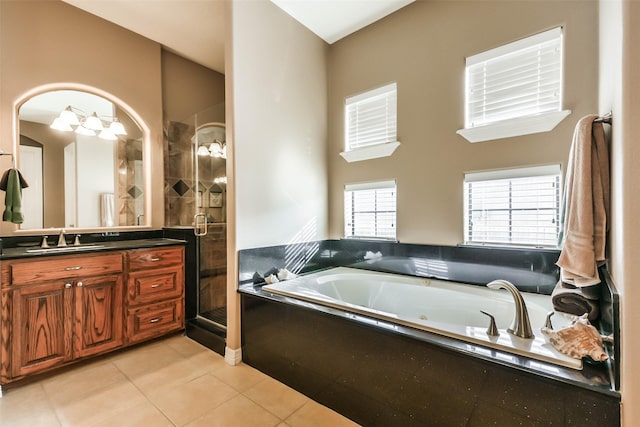 bathroom with tile patterned floors, vanity, and separate shower and tub