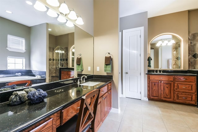 bathroom featuring tile patterned floors, separate shower and tub, and vanity