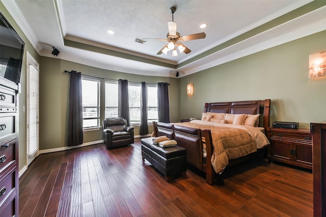 bedroom featuring ceiling fan, dark wood-type flooring, crown molding, and a tray ceiling