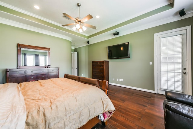 bedroom featuring a raised ceiling, ceiling fan, dark hardwood / wood-style flooring, and ornamental molding