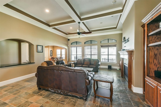 living room with ceiling fan, beam ceiling, crown molding, and coffered ceiling