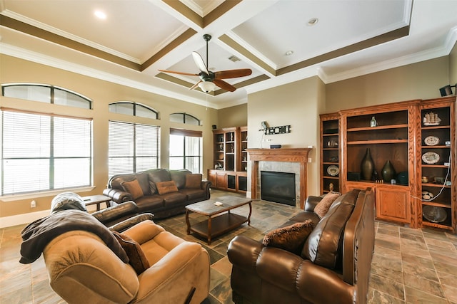 living room with beam ceiling, crown molding, a tile fireplace, and coffered ceiling