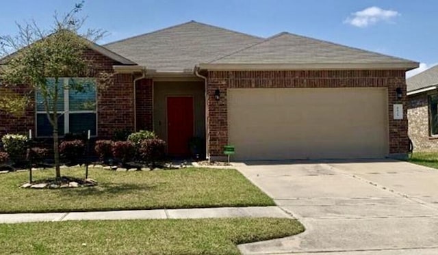 single story home featuring a front lawn and a garage