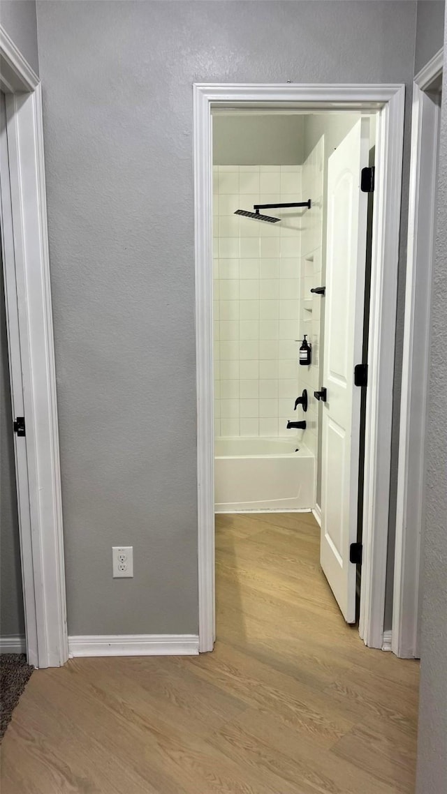 corridor with light hardwood / wood-style floors