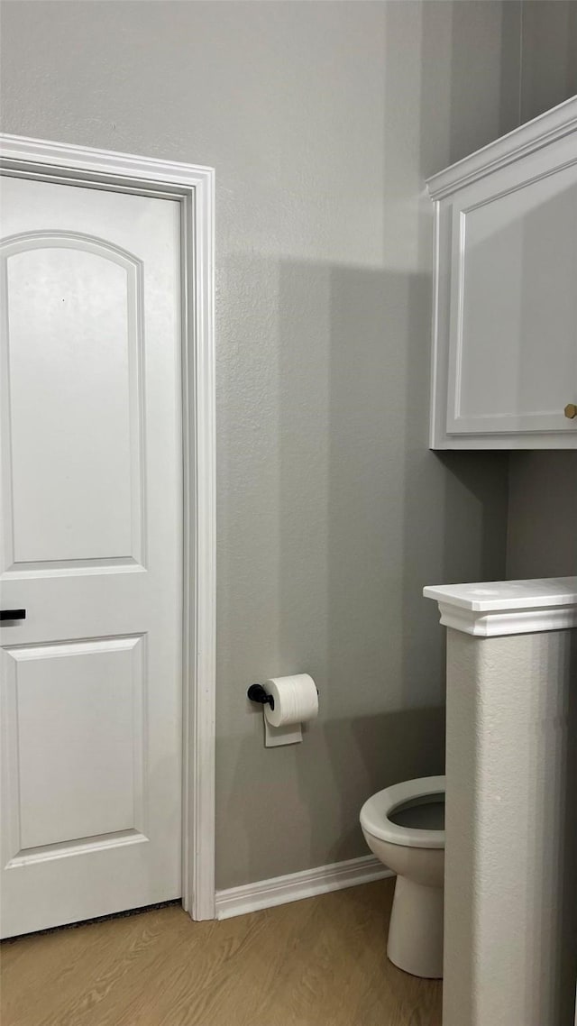 bathroom featuring toilet and hardwood / wood-style flooring