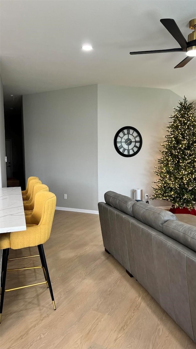 living room with light hardwood / wood-style floors and ceiling fan