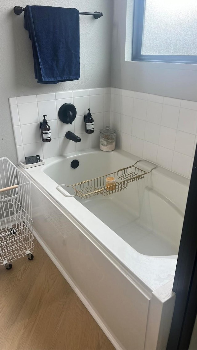 bathroom featuring a bathtub and wood-type flooring