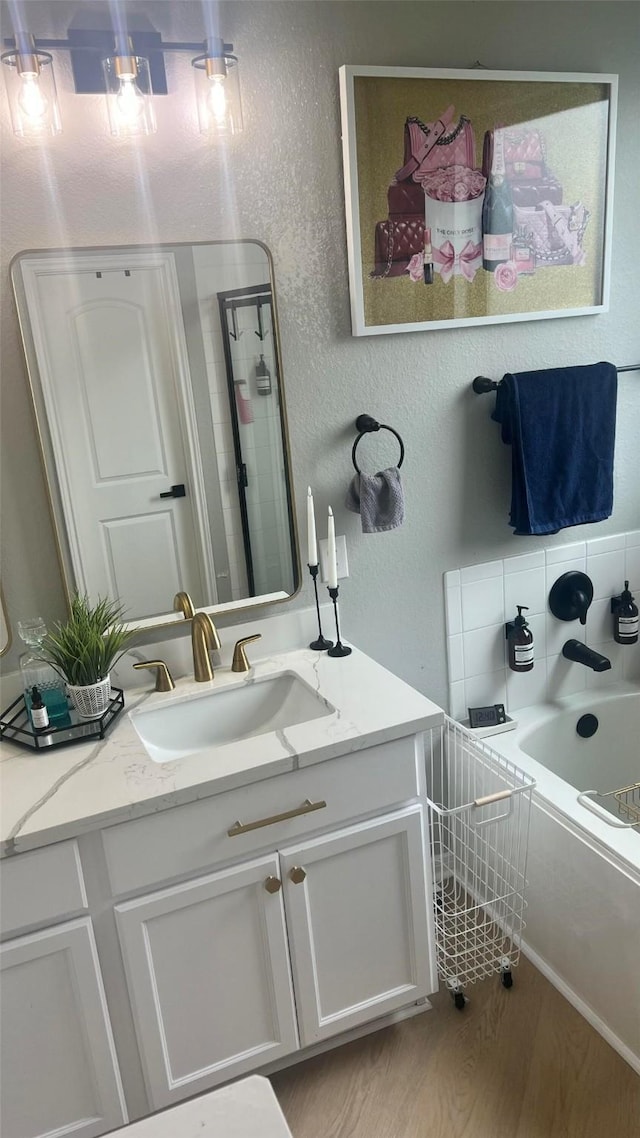 bathroom with vanity, hardwood / wood-style floors, and bathing tub / shower combination