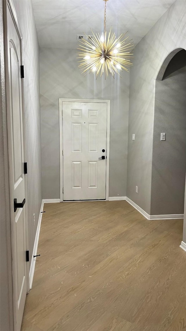 interior space with an inviting chandelier and hardwood / wood-style flooring