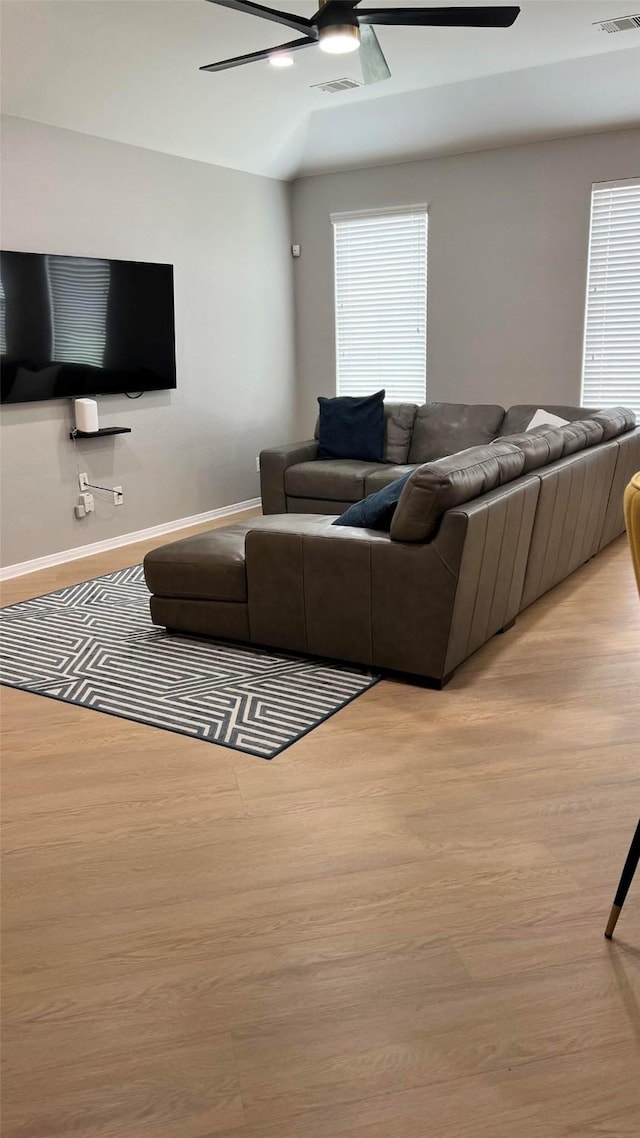 living room featuring vaulted ceiling and light hardwood / wood-style flooring