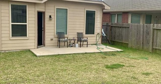 exterior space with a lawn and a patio