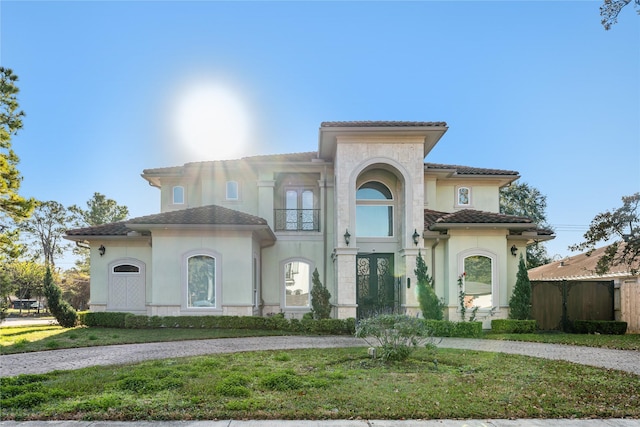 mediterranean / spanish-style home with a front yard