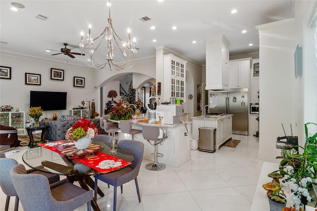 dining space with crown molding and ceiling fan